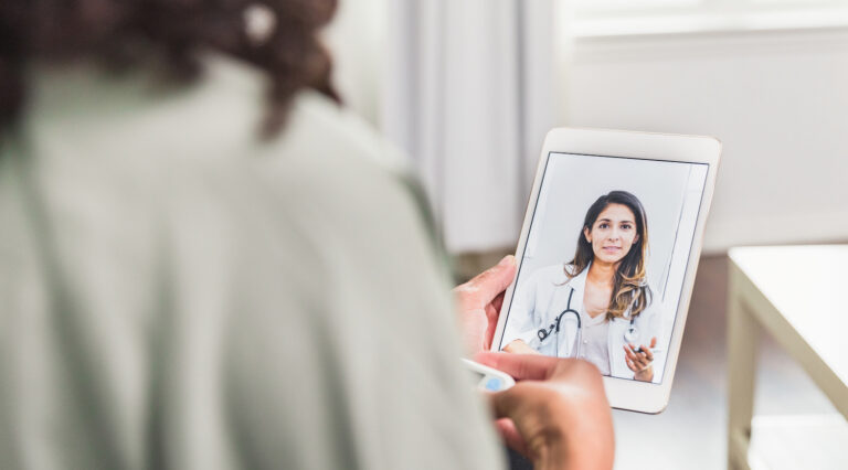 Female doctor talks with patient during telemedicine appointment